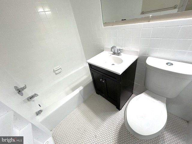 full bathroom with tile patterned flooring, tile walls, toilet, vanity, and shower / bathtub combination