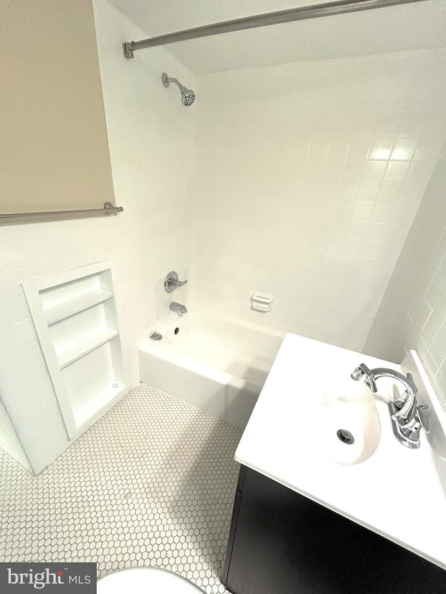 full bathroom with vanity, toilet, tile patterned flooring, and tiled shower / bath combo