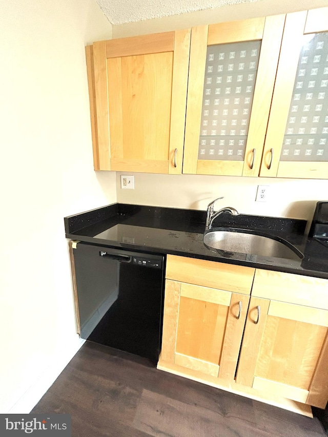 kitchen with black dishwasher, light brown cabinetry, a textured ceiling, sink, and dark hardwood / wood-style floors