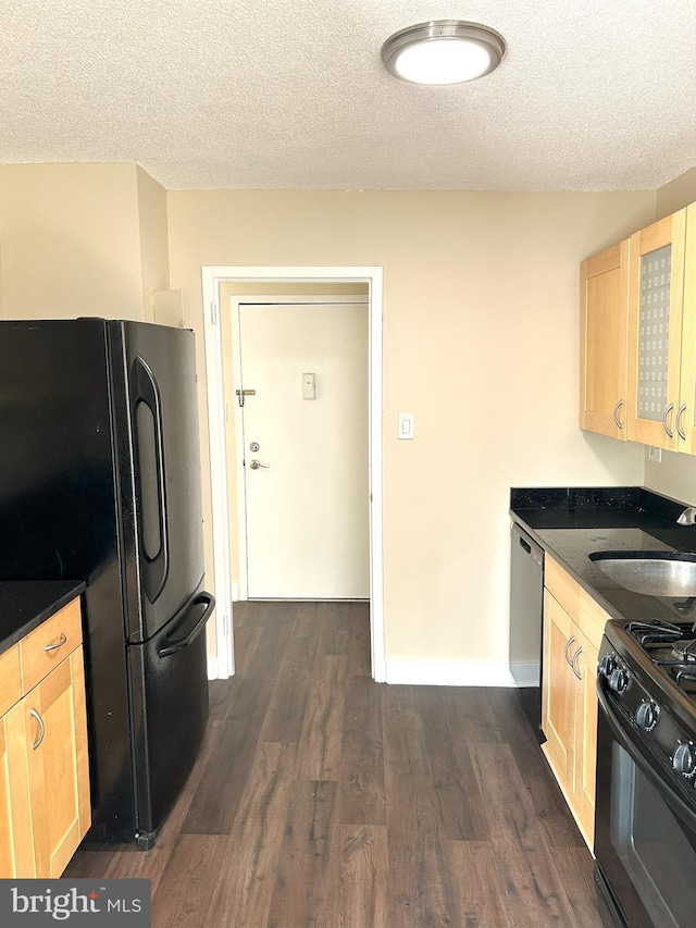 kitchen featuring a textured ceiling, black appliances, light brown cabinets, sink, and dark hardwood / wood-style floors