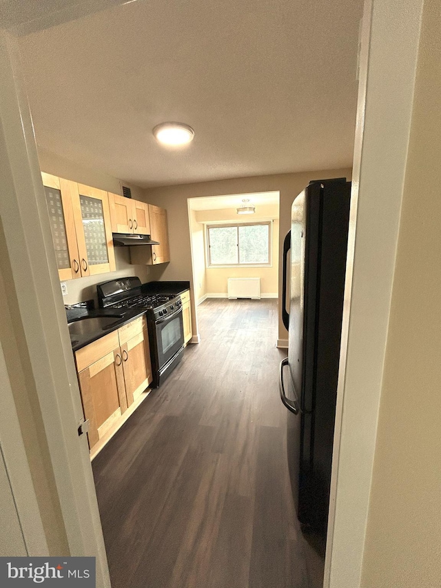 kitchen with black appliances, light brown cabinetry, a textured ceiling, sink, and dark hardwood / wood-style flooring