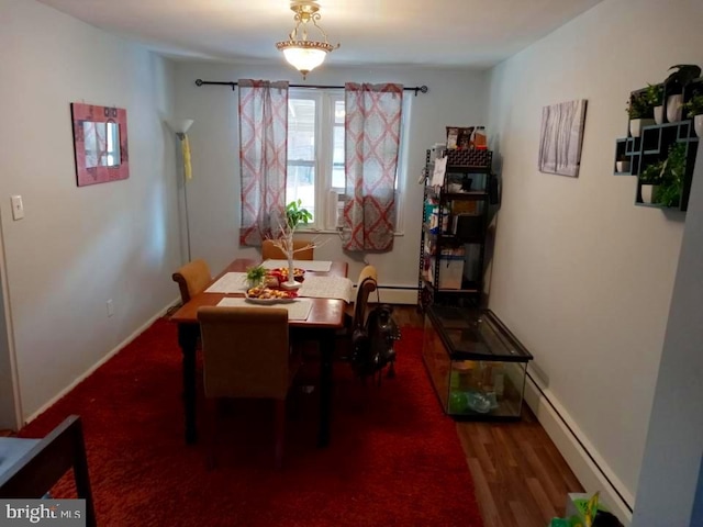 dining space with a baseboard radiator and wood-type flooring