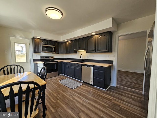 kitchen featuring sink, dark hardwood / wood-style floors, and appliances with stainless steel finishes