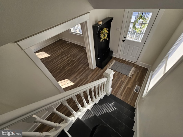 stairs featuring hardwood / wood-style flooring and lofted ceiling