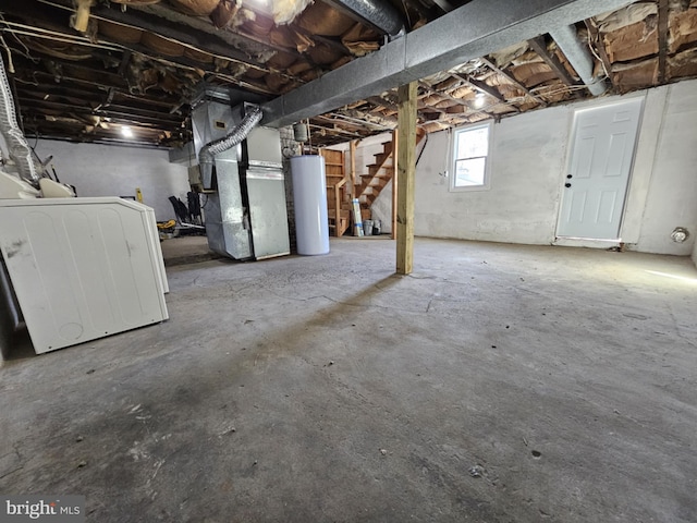 basement featuring water heater, washer / dryer, and heating unit