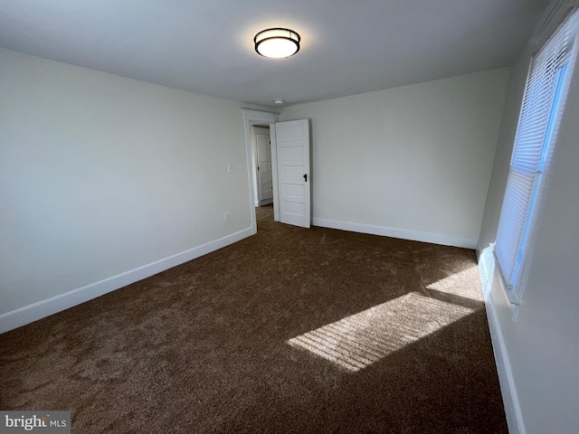 unfurnished bedroom featuring dark carpet