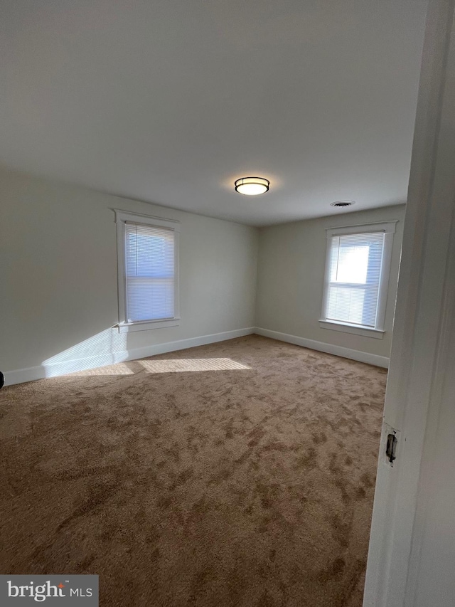 unfurnished room with carpet floors