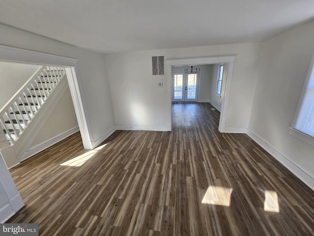 spare room with dark wood-type flooring and french doors