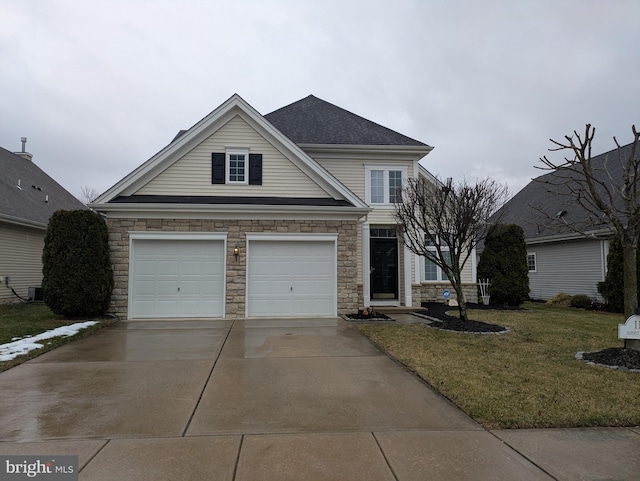 view of front property featuring a garage and a front lawn