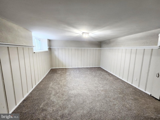 unfurnished room featuring dark colored carpet