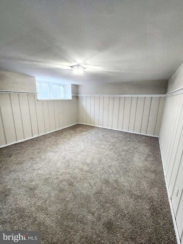 unfurnished room featuring dark colored carpet