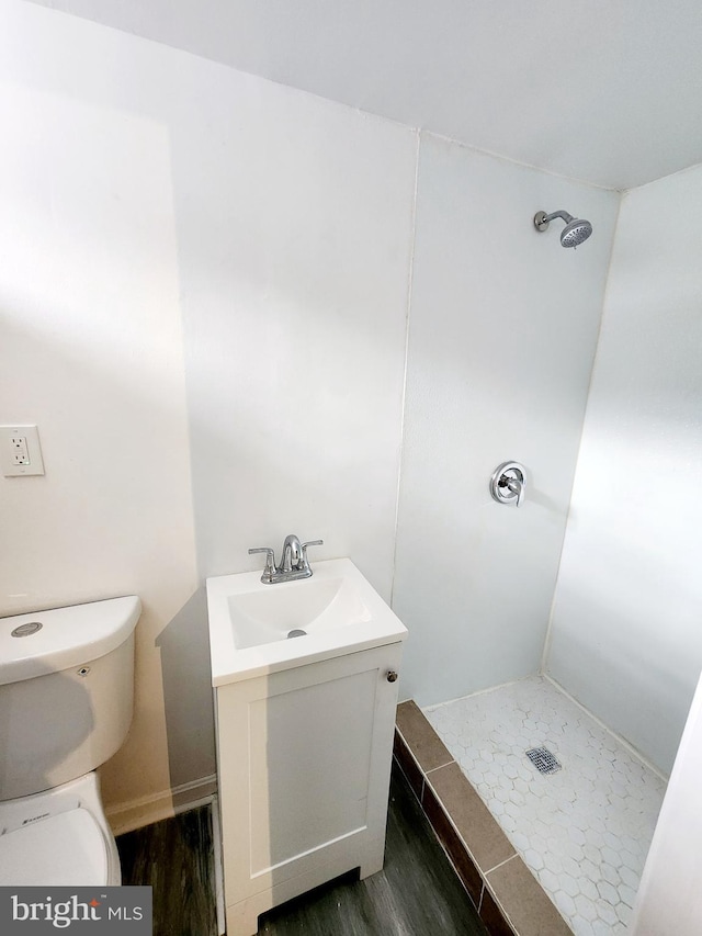 bathroom featuring vanity, hardwood / wood-style floors, toilet, and walk in shower