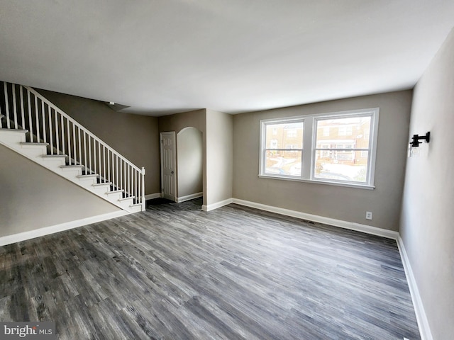 unfurnished living room featuring dark wood-type flooring