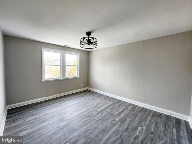 unfurnished room featuring dark hardwood / wood-style floors