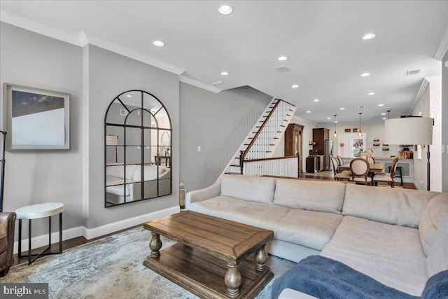 living room featuring hardwood / wood-style floors and crown molding