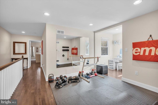 workout area with dark hardwood / wood-style floors