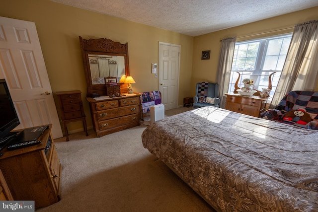 carpeted bedroom featuring a textured ceiling