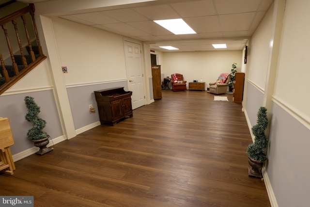 interior space featuring dark hardwood / wood-style floors and a drop ceiling