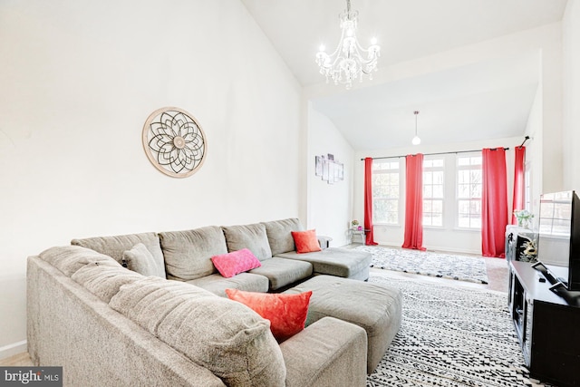 living room featuring lofted ceiling and a chandelier