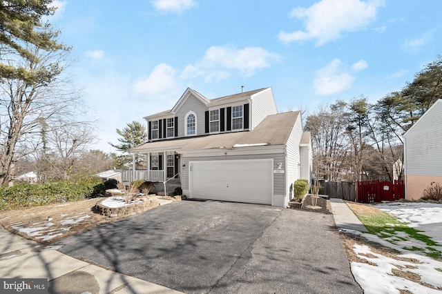 front of property featuring a garage and covered porch