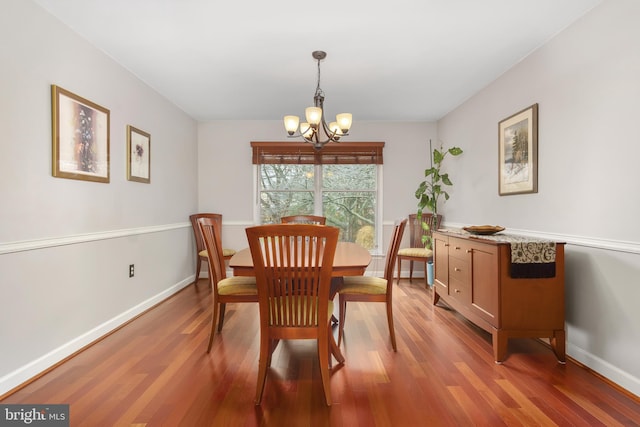 dining space featuring light hardwood / wood-style floors and a notable chandelier