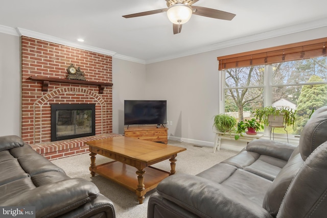 carpeted living room featuring ceiling fan, ornamental molding, and a fireplace