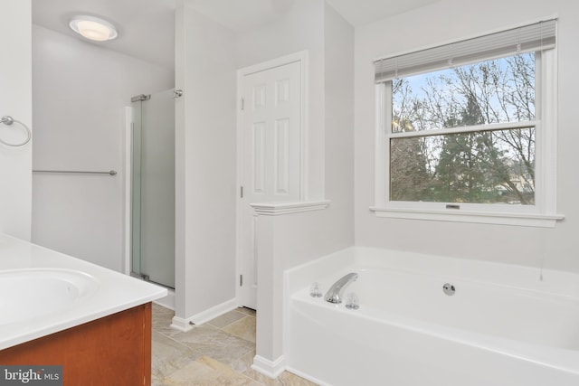 bathroom featuring vanity and separate shower and tub