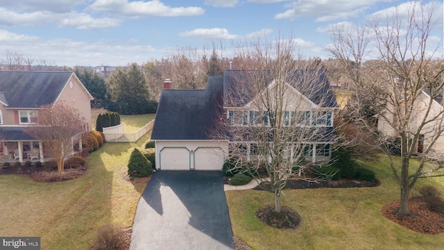 view of front facade with a garage and a front yard