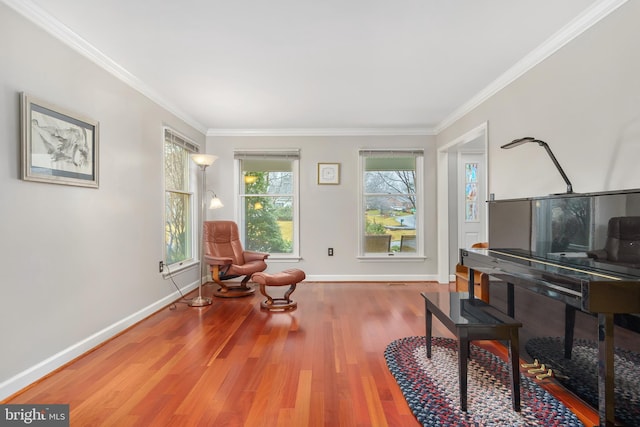 sitting room with crown molding and hardwood / wood-style flooring