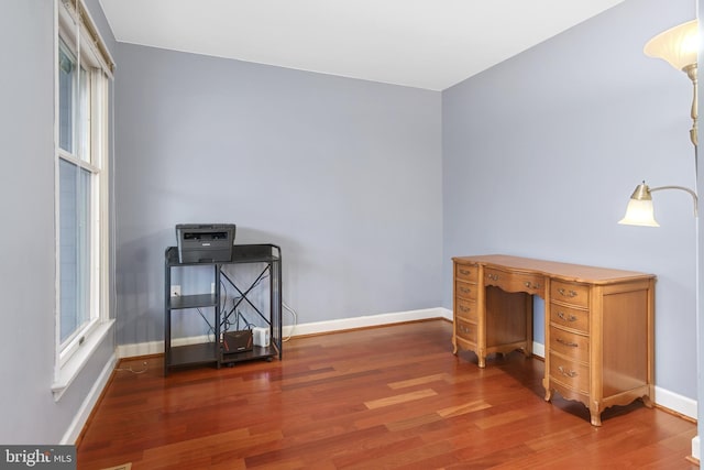 unfurnished office featuring dark wood-type flooring