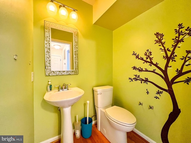 bathroom featuring hardwood / wood-style floors and toilet