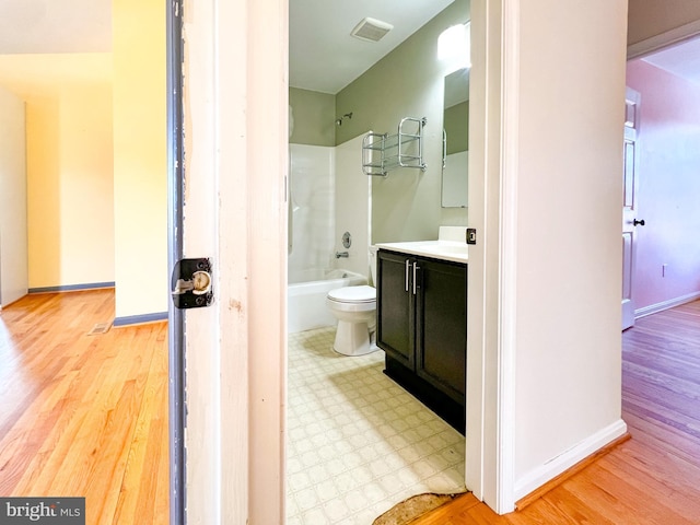 full bathroom featuring vanity, tub / shower combination, hardwood / wood-style floors, and toilet