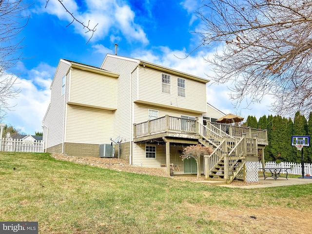 rear view of property featuring a yard, central AC, and a deck