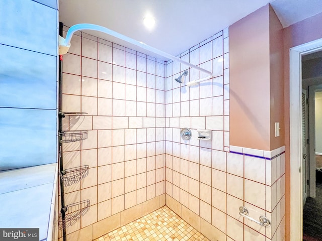 bathroom with a tile shower