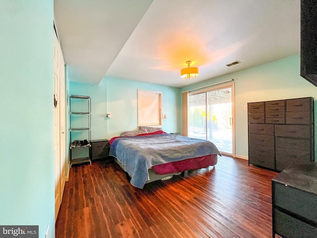 bedroom featuring dark hardwood / wood-style flooring and access to exterior