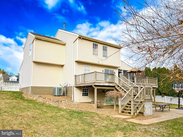 back of property featuring a patio area, cooling unit, a deck, and a lawn