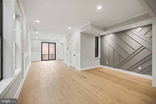 interior space featuring light hardwood / wood-style floors and crown molding