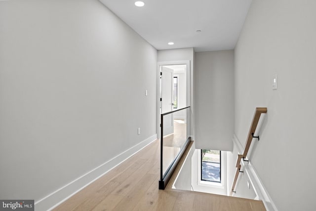 hallway with light hardwood / wood-style floors