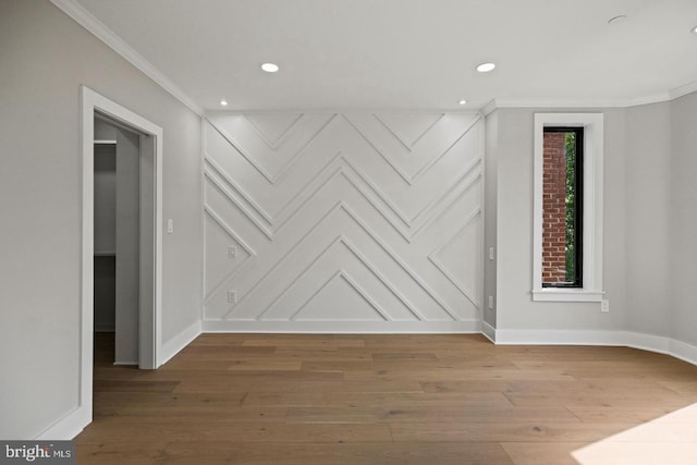 empty room with crown molding and wood-type flooring