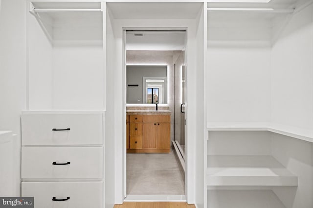 spacious closet featuring light hardwood / wood-style floors