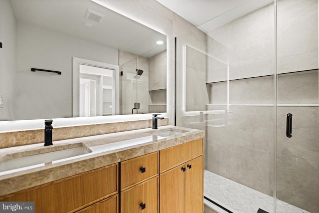 bathroom with vanity and a shower with door