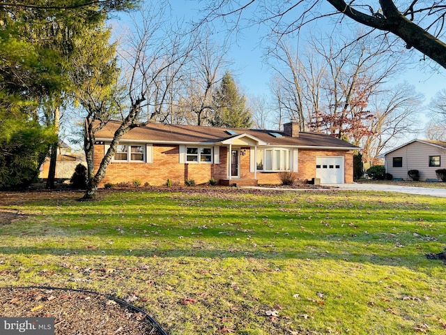 ranch-style home with a garage and a front lawn