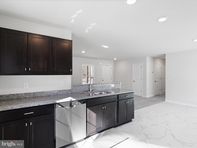 kitchen featuring light stone counters, sink, stainless steel dishwasher, and dark brown cabinetry