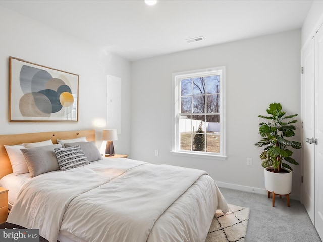 bedroom featuring light carpet