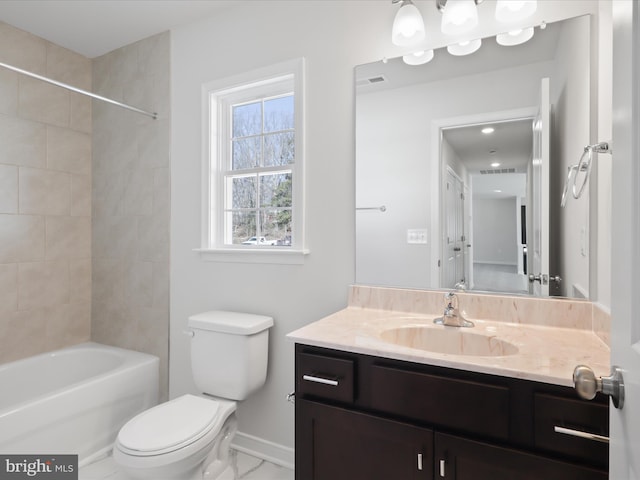 full bathroom featuring vanity, tiled shower / bath combo, and toilet