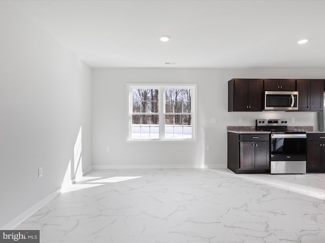 kitchen featuring appliances with stainless steel finishes and dark brown cabinets