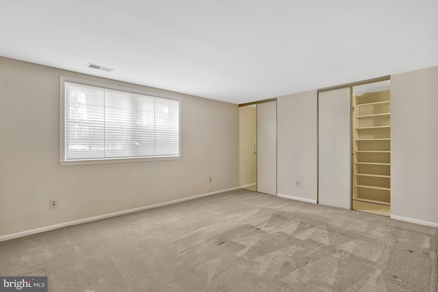 unfurnished bedroom with light colored carpet