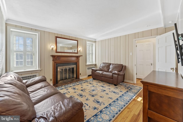 living room featuring hardwood / wood-style flooring and ornamental molding