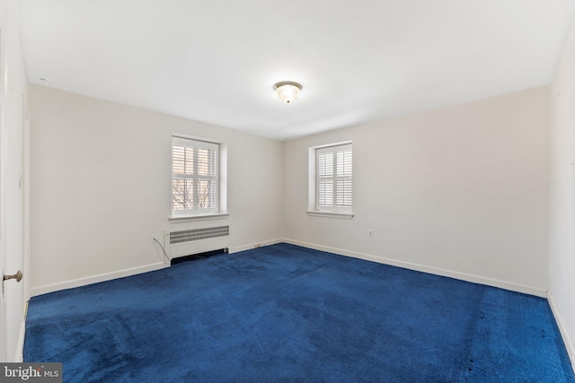 carpeted empty room with radiator