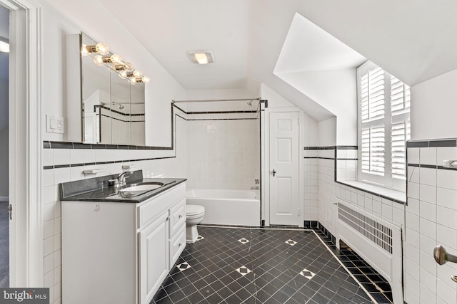 full bathroom with radiator heating unit, tile walls, vanity, toilet, and tile patterned floors